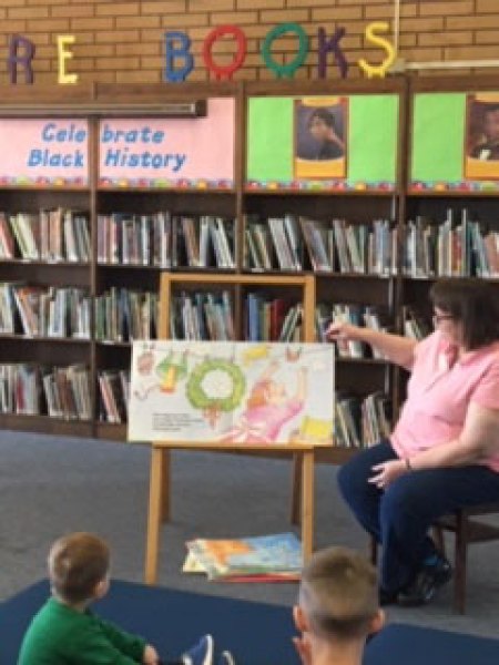 Alice Quezada, a Book Buddie and vice president of Friends of the Kings County Library reads a book during Storytime at the Hanford Branch.